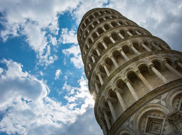 The Leaning Tower of Pisa against a blue sky.