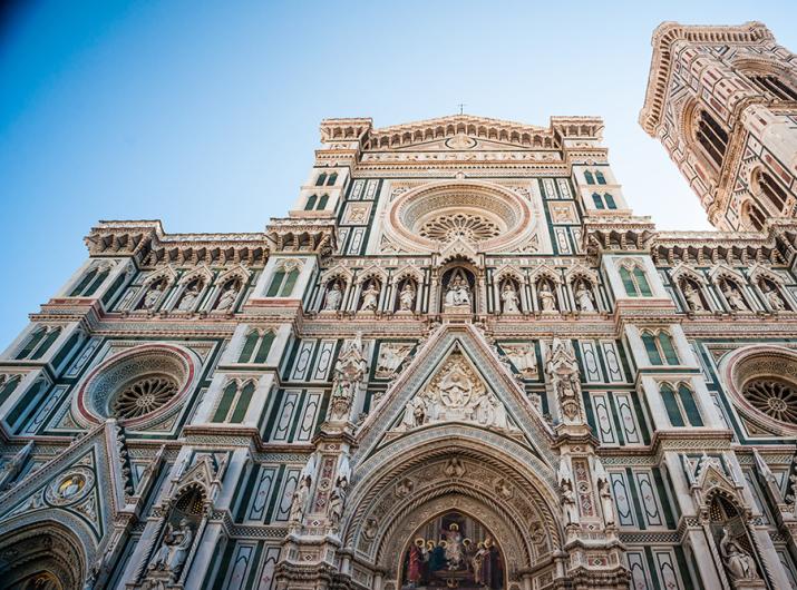 Facade of Florence Cathedral with Gothic details and vibrant colors.