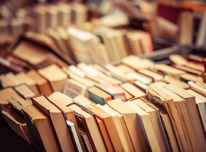 Stacks of used books in a bookstore.