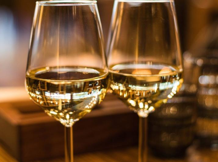 Two glasses of white wine on an elegant table.