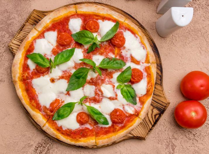 Margherita pizza with fresh basil and tomatoes.